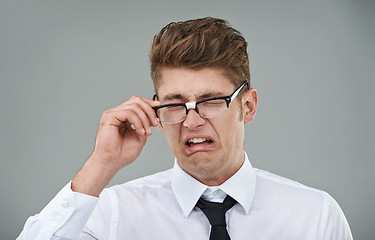 Image showing Businessman, glasses and disgust in studio for optical healthcare, omg and overwhelmed on gray backdrop. Male person, eyewear and dislike the frame choice, optometry and lens for vision support