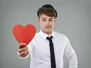 Image showing Portrait, man and heart in studio holding greeting card for Valentines day, romantic and mockup. Hopeful, trendy guy and gen z hipster with shirt, tie and smile against light grey background