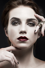Image showing Beauty, woman and gothic makeup in studio with portrait for cosmetics, art deco aesthetic with edgy jewelry. Face of model in villain character, vampire and red lipstick on a dark or black background