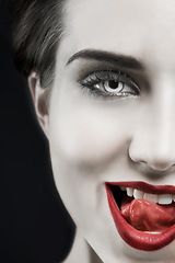 Image showing Woman, portrait and gothic lips in studio for beauty, cosmetics and dark aesthetic with smirk and edgy. Face of model in villain character, fantasy contact lens and red lipstick on a black background