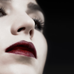 Image showing Woman, lips and gothic makeup in studio for beauty, cosmetics and vampire, witch or dark aesthetic. Face of model with lipstick closeup for Halloween, art and color at night or on a black background