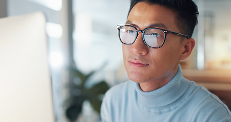 Image showing Asian man at computer, glasses and reflection, thinking and reading email, review or article at digital agency. Internet, research and businessman at tech startup with report, networking or feedback.