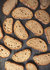 Image showing Assorted sliced artisan bread on wooden background