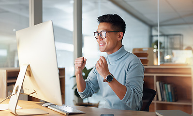 Image showing Happy asian man, fist pump and celebration for winning, promotion or bonus on computer at office. Excited male person or employee wow in achievement, target or good news for victory, success or deal