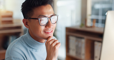 Image showing Asian man at computer, glasses and ideas, thinking and reading email, web review or article at digital agency. Research, reflection and businessman at tech startup networking on business website.