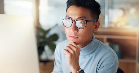 Image showing Man at computer, glasses and reflection, thinking and reading email, review or article at digital agency. Internet, research and Asian businessman at tech startup with report, networking or feedback.
