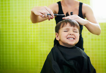 Image showing Child, boy and hairdresser with haircut at salon for grooming, hairstyle and grimace with scissors. Barber, person and kid for hair treatment, haircare and hairdressing with comb or happy with mockup