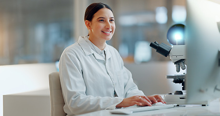Image showing Science, research and happy woman with computer, typing and biotech data report in laboratory. Medical innovation, scientist or lab technician in study in healthcare, medicine or online test feedback