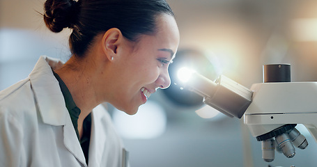 Image showing Science, research and happy woman with microscope, technology or biotech data in laboratory. Medical innovation, scientist or lab technician in study in healthcare, medicine or pharmaceutical future