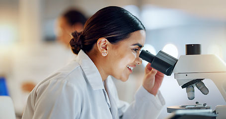 Image showing Science, research and happy woman with microscope, technology or biotech data in laboratory. Medical innovation, scientist or lab technician in study in healthcare, medicine or pharmaceutical future