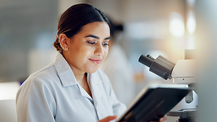 Image showing Scientist, woman and tablet, microscope or laboratory research for DNA analysis and happy with medical study. Student or science expert in biotechnology with digital software and lens check for data