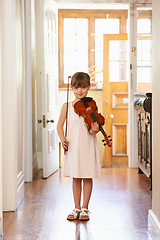 Image showing Violin, girl and portrait of child in home for learning, practice or music education. Art, fiddle and student with bow for talent, creative or hobby in house with acoustic string instrument in Canada