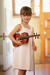 Image showing Violin, girl and portrait of happy kid in home for learning, practice and music education. Art, fiddle and student with bow for talent, creative or hobby with acoustic string instrument in Canada