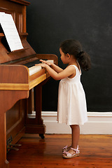 Image showing Piano, girl and toddler in home for learning, practice and classical education with musical notes. Training, melody and kid with talent, creative or hobby with instrument, child development or skill