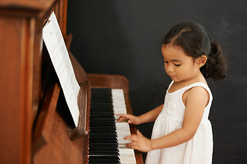Image showing Piano, girl and kid in home for learning, practice and classical education with musical notes. Training, melody and student with talent, creative or hobby with instrument, child development or skill