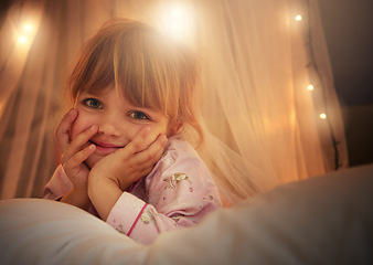 Image showing Bed, lights and portrait of child at night for resting, relaxing and dreaming in home. Happy, smile and face of young girl with fairy light decoration in bedroom for fantasy, magic and childhood