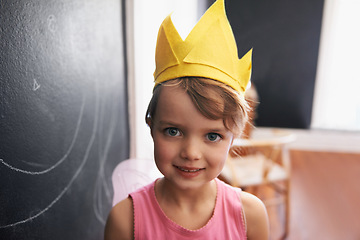 Image showing Portrait, paper crown and child with smile for birthday celebration at kindergarten in Germany. Kid, female student or girl beaming in classroom with blackboard for party, fun and play inside