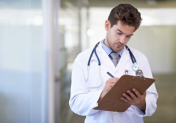 Image showing Writing, clipboard and doctor in hospital for medical research information for diagnosis or treatment. Checklist, professional and male healthcare worker with documents or notes in medicare clinic.