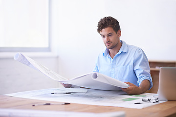Image showing Architect, contractor or man in office with blueprint, thinking and reading paper for renovation. Designer, engineer or creative developer at desk with building plan, remodeling or property upgrade.