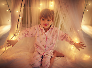 Image showing Happy, lights and portrait of child in bedroom for resting, relaxing and dreaming in home. Night, smile and face of young girl with fairy light decoration on bed for fantasy, magic and childhood