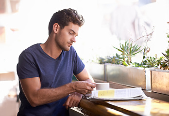 Image showing Man, coffee shop and relaxing with newspaper and cup, hot beverage and article for information. Male person, restaurant and reading paper for announcement, print and story for update and tea at cafe