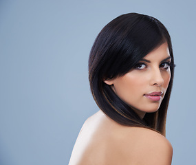 Image showing Beauty, hair care and portrait of woman with cosmetics in studio for health, wellness and salon treatment. Confident, makeup and person with face and hairstyle routine by blue background with mockup.