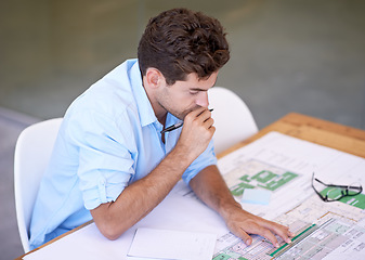 Image showing Architect, thinking or man in office with blueprint, brainstorming and reading paper for building project. Designer, engineer or creative developer at desk with floor plan for remodeling upgrade.