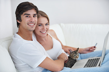 Image showing Couple, living room and cat with laptop, sofa and credit card for online shopping, relaxation or date. People, computer and pet with portrait, home and kitten with love and smile for happiness