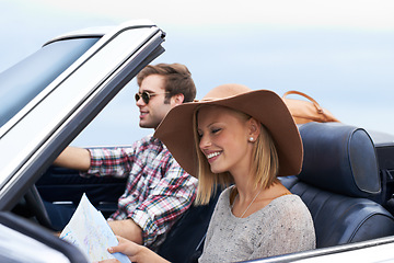 Image showing Map, driving and couple in a car for travel to vacation, adventure or holiday destination. Happy, navigation guide and young man and woman on journey in vehicle for weekend road trip together.