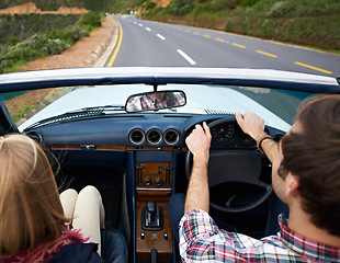 Image showing Couple, driving and convertible steering wheel on road from behind on mountain for vacation, adventure or holiday. Man, woman and transportation in California for travel destination, relax or nature