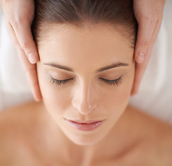 Image showing Hands, top view and facial massage of woman at spa to relax, peace and closeup at luxury resort with masseuse. Above, therapy and person at salon for face treatment, skincare and beauty for wellness