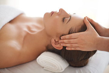 Image showing Hands, head massage and woman at salon to relax, wellness and calm at luxury resort for therapy with masseuse for health. Closeup, face and person at spa for facial treatment, skincare and beauty