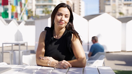 Image showing Elegant Woman Enjoying Sunny Day at Outdoor Cafe