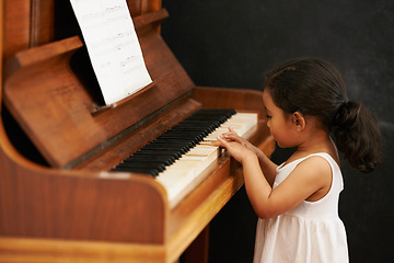 Image showing Piano, kid and toddler in home for learning, practice and classical education with musical notes. Training, melody and girl with talent, creative or hobby with instrument, child development or skill