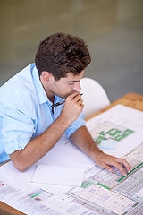 Image showing Architecture, brainstorming and man in office with blueprint, thinking and reading paper for renovation. Designer, engineer or creative developer at desk with floor plan or remodeling with high angle