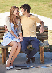 Image showing Smile, love and couple on bench in nature on a valentines day, anniversary or romantic date. Happy, connection and young man and woman embracing, sitting and bonding together in outdoor park.