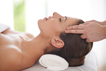 Image showing Head, massage and hands on woman in spa to relax on table for skin care, treatment or facial. Beauty, person and calm girl in luxury salon or resort on holiday or vacation with health and wellness