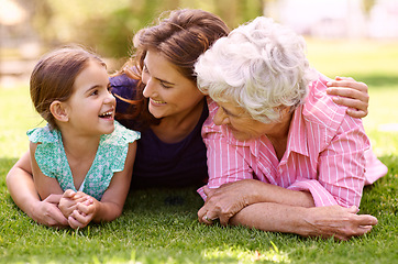 Image showing Grandmother, mom and child hug outdoor to relax in summer, holiday or vacation together. Happy, family and elderly mother smile on grass with kid in garden with love and support in retirement