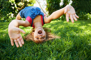 Image showing Child, back and bend or bridge for play in summer or flexibility game or practice, fun or backyard. Kid, face and hands or gymnastics stretching with head balance on grass in London, happy or garden
