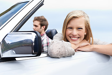 Image showing Woman, portrait and man driving convertible for travel adventure for vacation, road trip or holiday. Couple, relax and transportation with smile in California for weekend journey, together or bonding