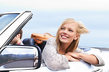 Image showing Woman, smile and man driving convertible for travel adventure for vacation, road trip or holiday. Couple, relax and transportation for dating in California for weekend journey, together or bonding