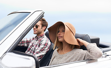 Image showing Couple, convertible and driving on road or adventure in California or outdoor journey, sun hat or vacation. Man, woman and environment on mountain or relaxing trip with transport, weekend or happy