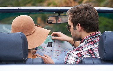 Image showing Map, travel and back of couple in a car for driving to vacation, adventure or holiday destination. Reading, navigation guide and young people on journey in vehicle for weekend road trip together.