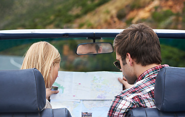 Image showing Map, driving and back of couple in a car for travel to vacation, adventure or holiday destination. Reading, atlas guide and young man and woman on journey in vehicle for weekend road trip together.