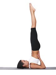 Image showing Woman, yoga and stretching in pilates workout, exercise or training on a white studio background. Female person or yogi in warm up, balance or shoulder stand pose for zen or fitness on mockup space