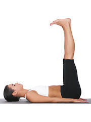 Image showing Woman, yoga and stretching legs in pilates for exercise, training or workout on a white studio background. Female person or yogi in body warm up, balance or pose for zen or fitness on mockup space