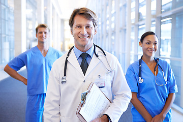 Image showing Happy, teamwork and portrait of doctors in hospital for medical service, life insurance and support. Healthcare, clinic and men and women with clipboard for collaboration, consulting and medicine