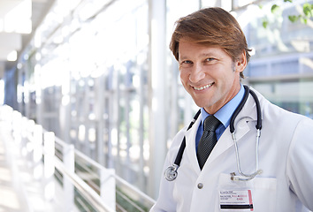 Image showing Happy, pride and portrait of doctor in hospital with positive, good and confident attitude. Smile, medical career and face of professional mature male healthcare worker in medicare clinic corridor.