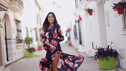 Image showing Elegant Woman Twirling in Floral Dress on Spain Street