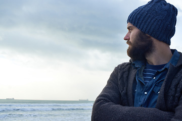 Image showing Calm, thinking and man at beach with memory, nostalgia or reflection with ocean view in nature. Remember, travel and male person at sea for fresh air, journey or peaceful Florida vacation in winter